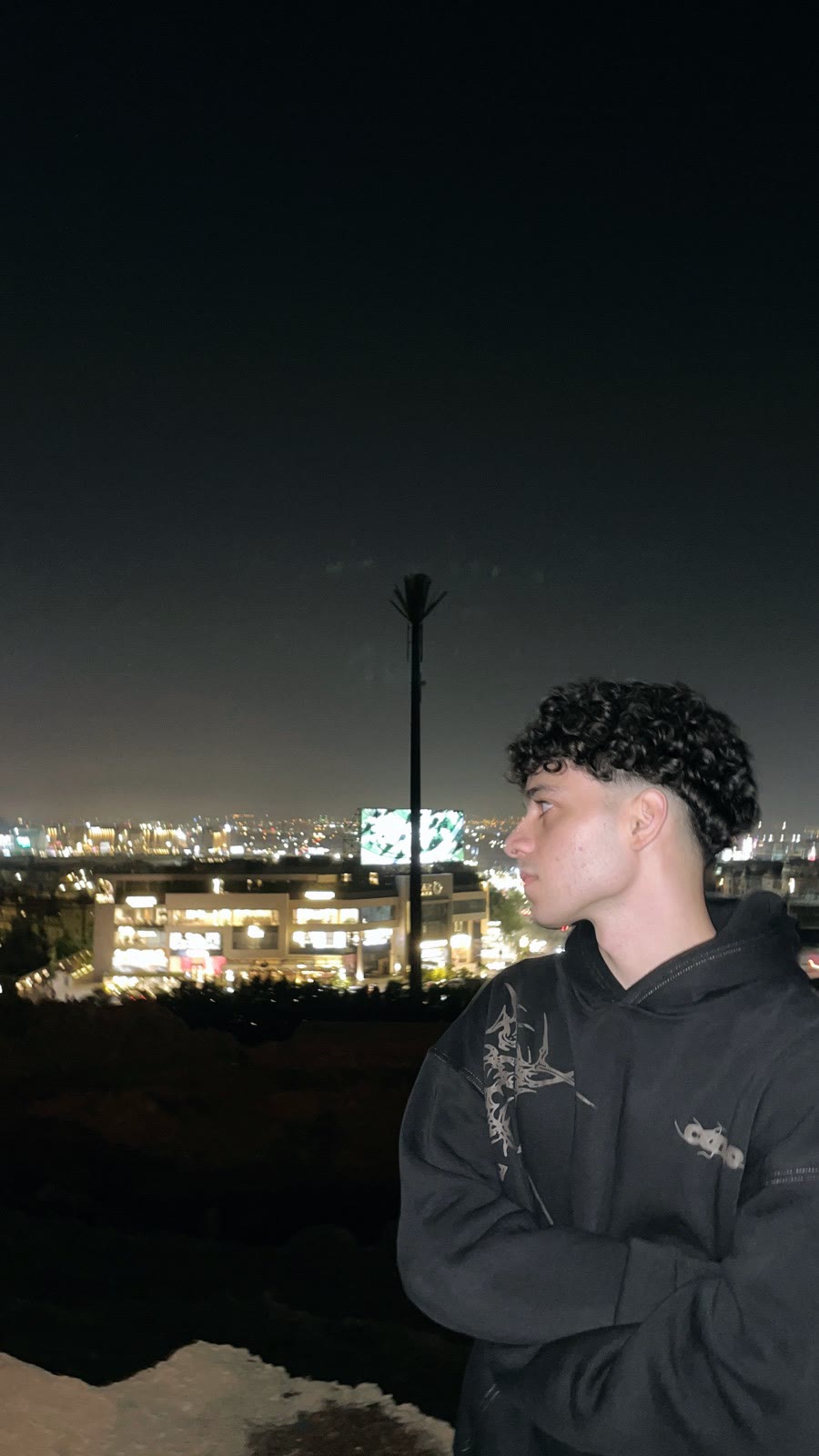 Ziad looking out over the city lights at night