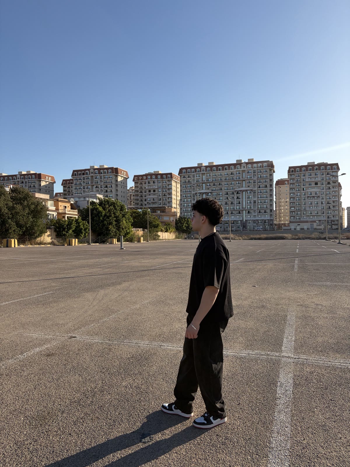 Ziad standing in an open lot at golden hour